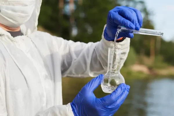 Image of a contaminated water warning sign at Camp Lejeune, with a faint image of military personnel in the background, highlighting the water contamination scandal